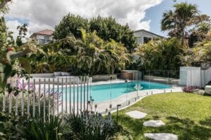 A spa and day bed enticethe family to use every area within the Collaroy Plateau Dreamgarden. Lush plantings create a border and help the mixedmaterial pool fence to blend into the landscape. Image: Landscape Contractor